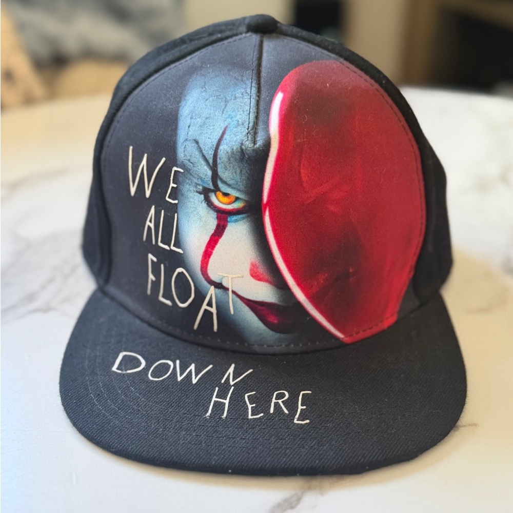 Limited edition memorabilia: 'We all float down here.” Snap back.